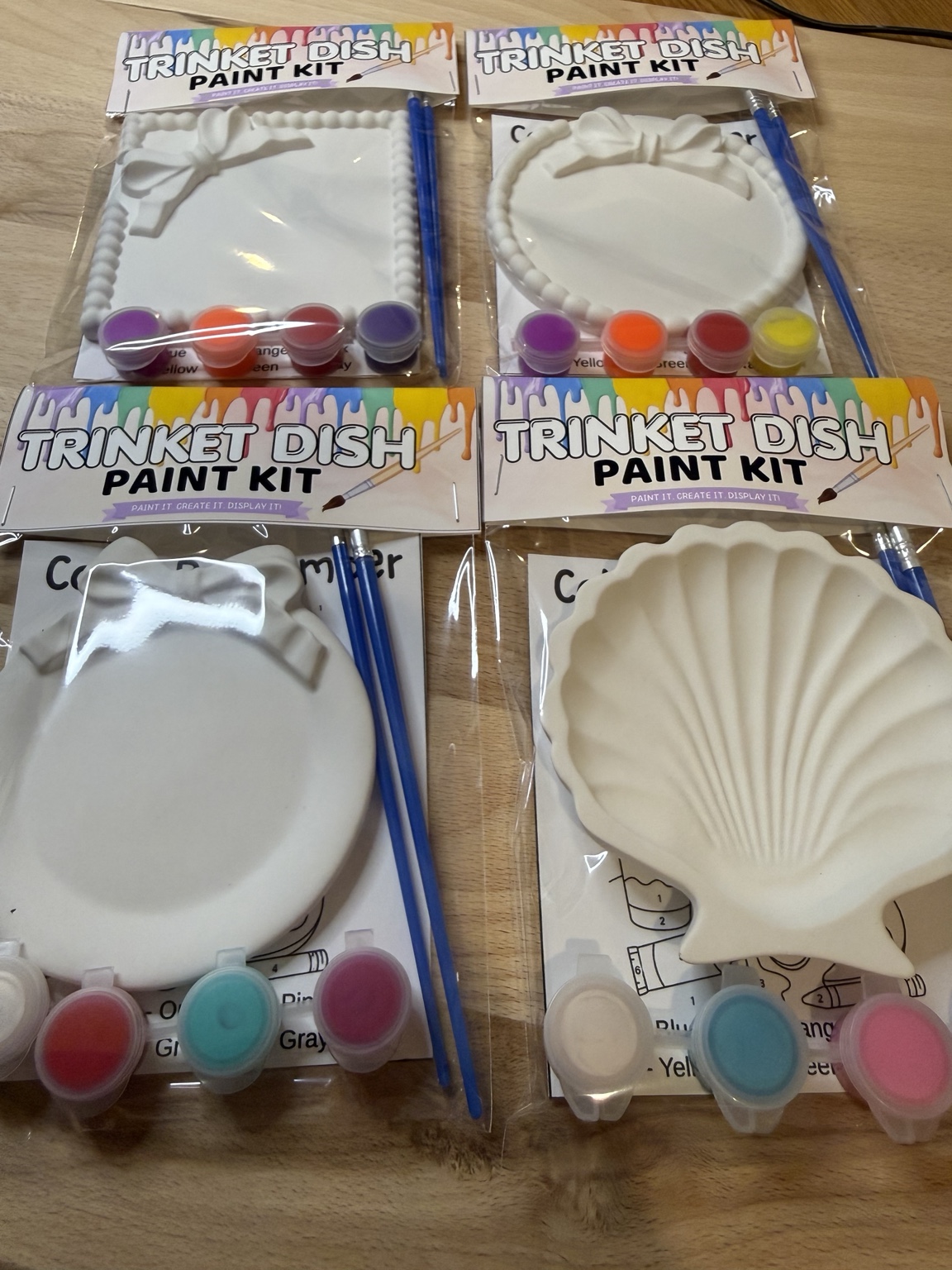Multiple trinket dish paint kits arranged together